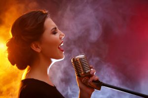 Elegant,Woman,Singing,In,Colourful,Smoke,,Close,Up